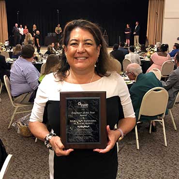 Becky Starkweather holding Engineer of the Year award from the Tampa Bay section of the Society of Women Engineers
