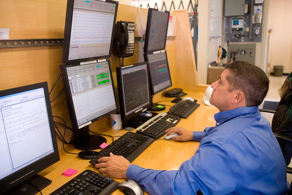 Man with many monitors